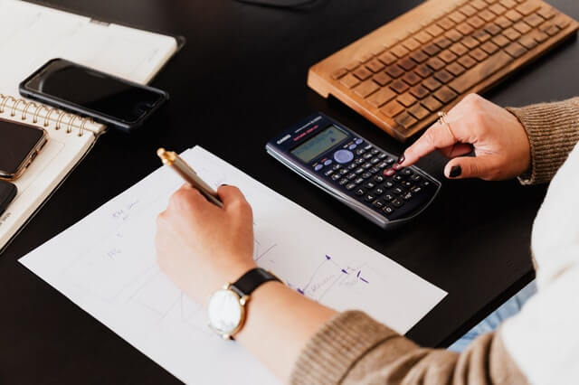 crop-woman-using-calculator-and-taking-notes-on-paper.jpg
